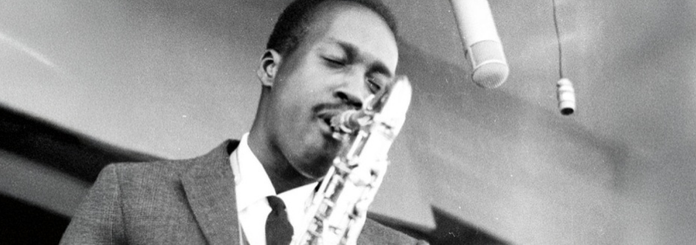 A passionate saxophonist, Hank Mobley, immersed in the soulful sound of his performance.