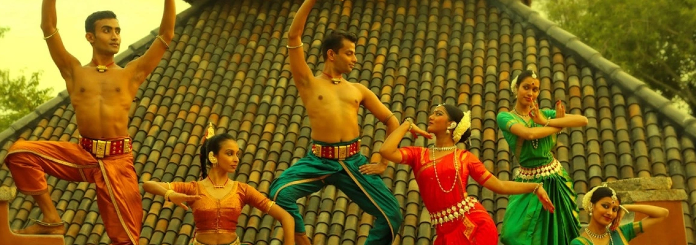 Traditional indian dancers in vibrant attire performing outdoors with expressive poses and synchronized movements, capturing the essence of cultural heritage and artistry.