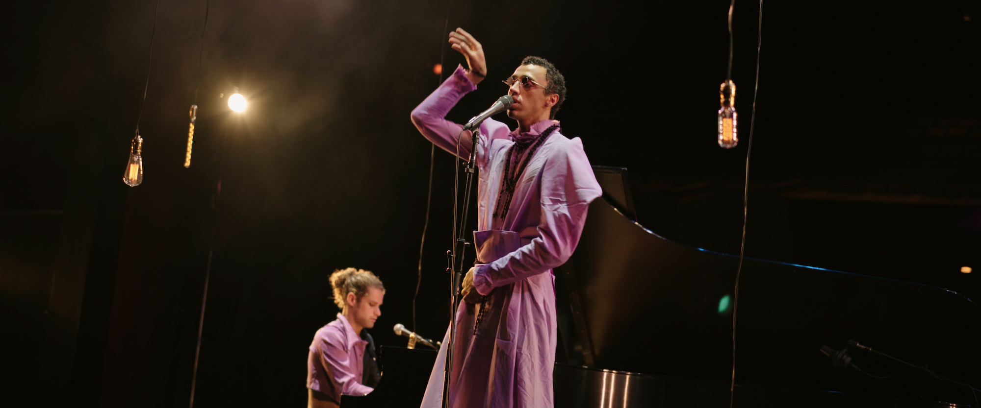 Soulful performance: a musician serenades the crowd, lost in the rhythm and mood under the warm glow of stage lights.