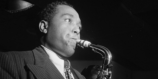 A black-and-white image of a man playing the saxophone, capturing the essence of a jazz performance with focus and intensity.
