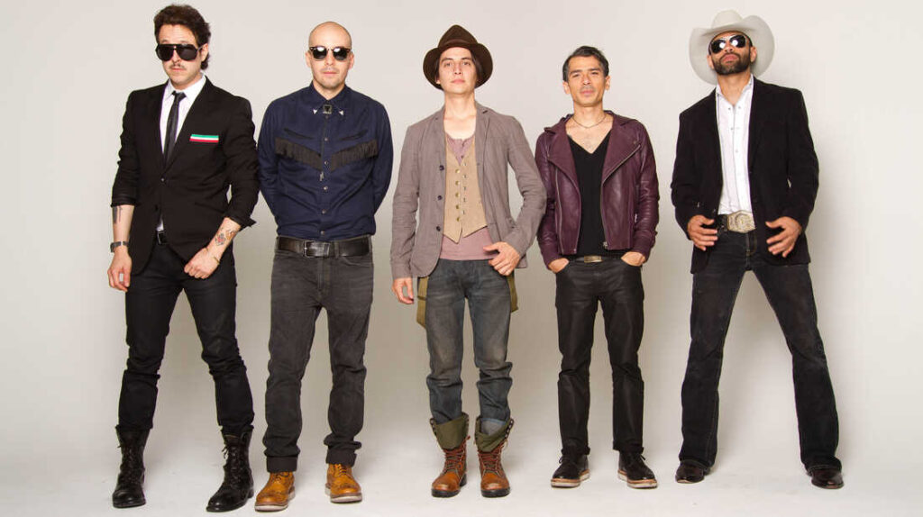 Five stylish men standing side-by-side against a neutral background, each showcasing their individual fashion sense with a mix of casual and edgy outfits.