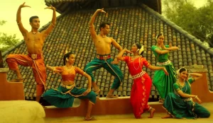 Traditional indian dancers in vibrant attire performing outdoors with expressive poses and synchronized movements, capturing the essence of cultural heritage and artistry.
