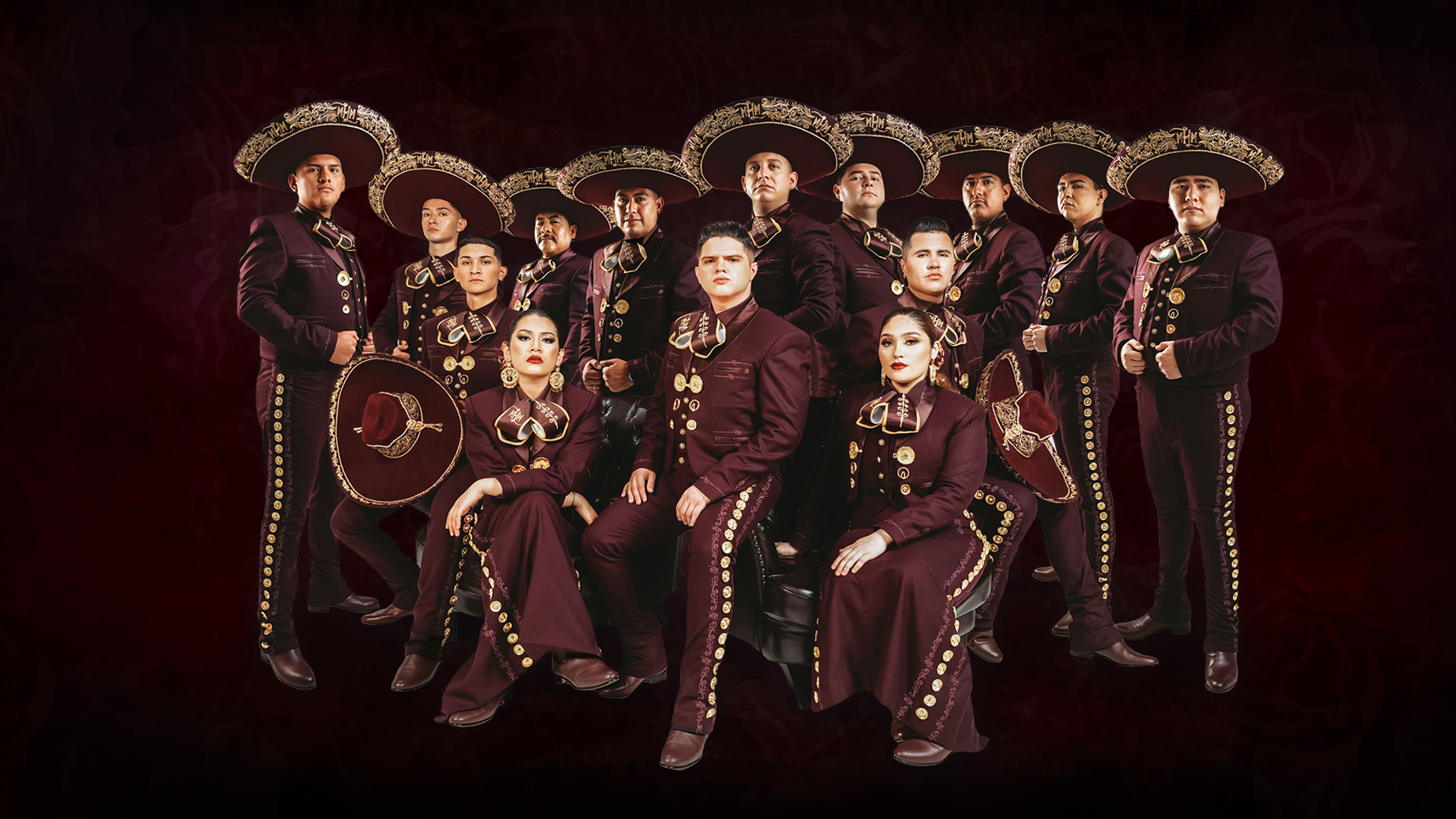 A mariachi band in traditional attire posing confidently against a dark red background.