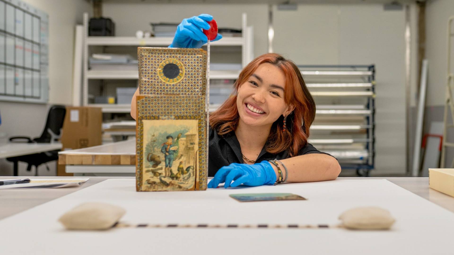 A woman measures a museum item